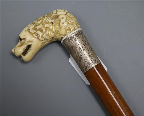 A carved ivory dogs head handled cane